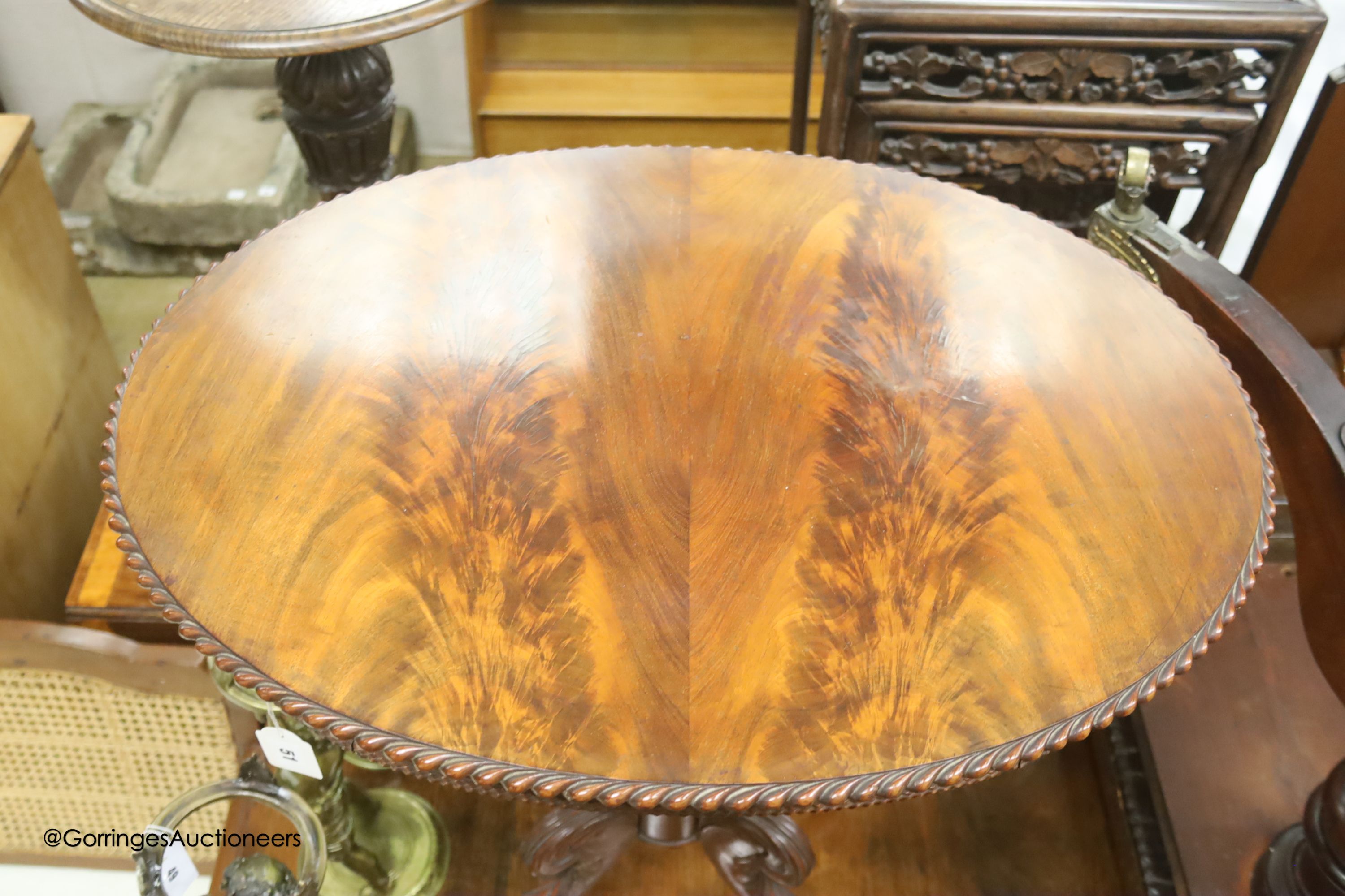 An oval French flamed mahogany occasional table, width 70cm, depth 52cm, height 74cm